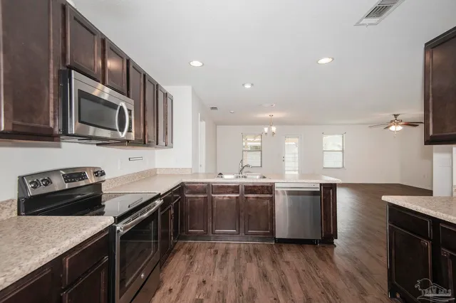 a kitchen with stainless steel appliances granite countertop counter space a sink and cabinets