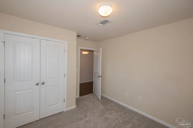 an empty room with closet area