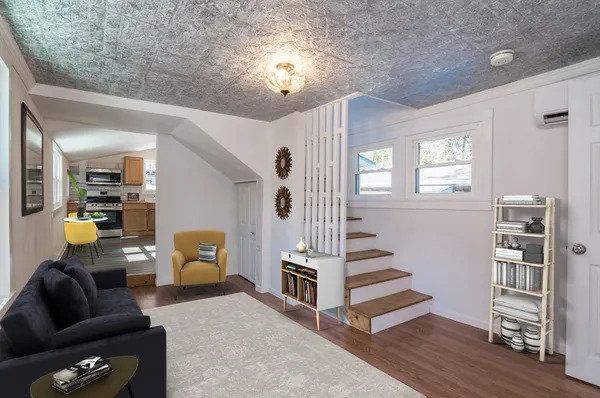 a living room with furniture and wooden floor