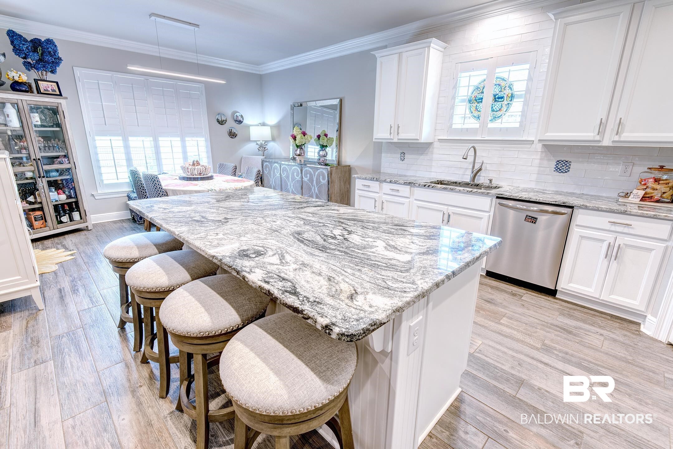 9988 Dunleith Loop Daphne, AL 36526 - Photo 35 of 51 Kitchen with light hardwood / wood-style floors, stainless steel dishwasher, hanging light fixtures, a center island, and white cabinetry