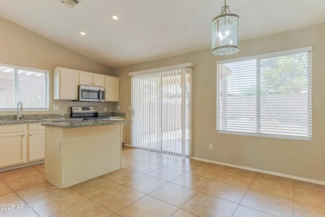 a kitchen with stainless steel appliances granite countertop a stove and a sink with granite countertops