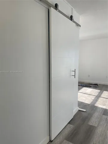 a view of hallway with wooden floor