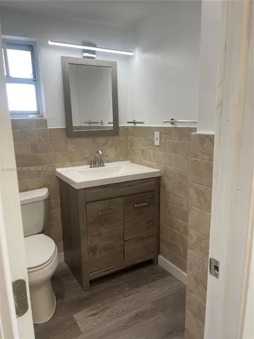 a view of a porch with a floor to ceiling window next to a yard