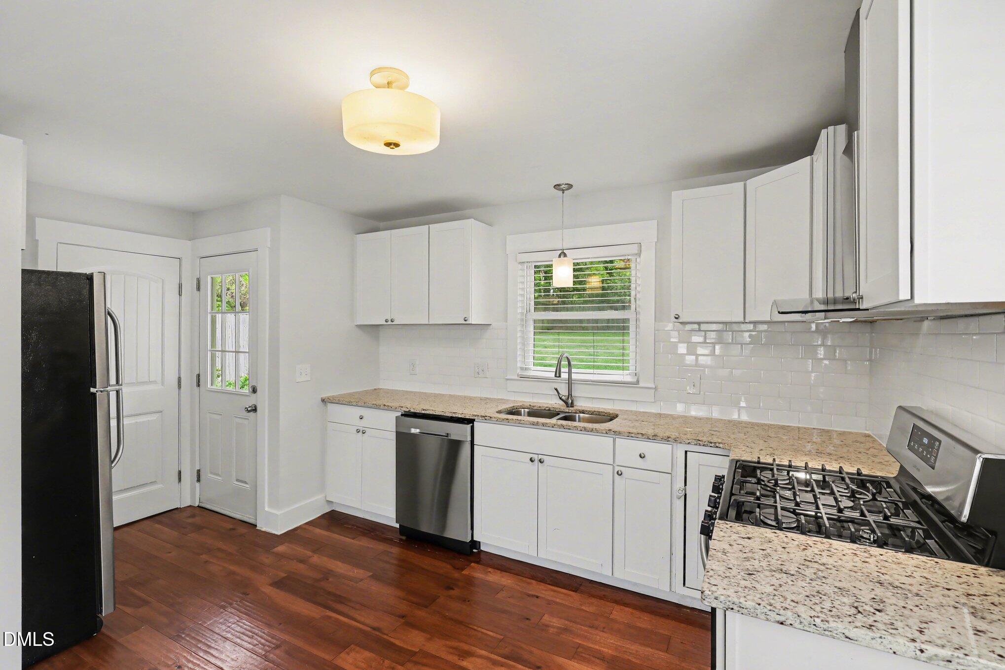727 South State Street Raleigh, NC 27601 - Photo 10 of 30 a kitchen with a sink cabinets stainless steel appliances and a window
