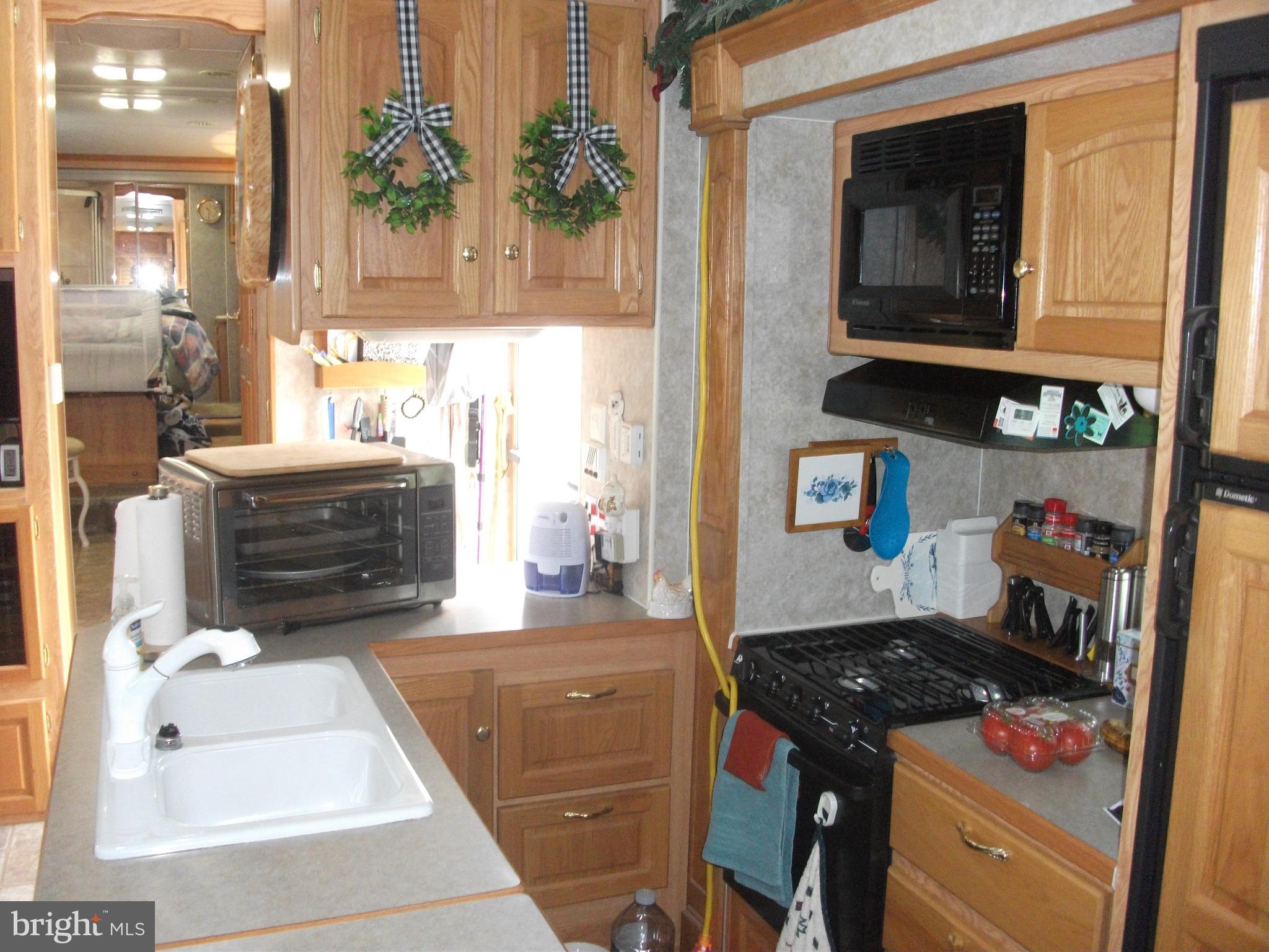 216 Garland Road Needmore, PA 17238 - Photo 13 of 38 a kitchen with a stove and a wooden floor