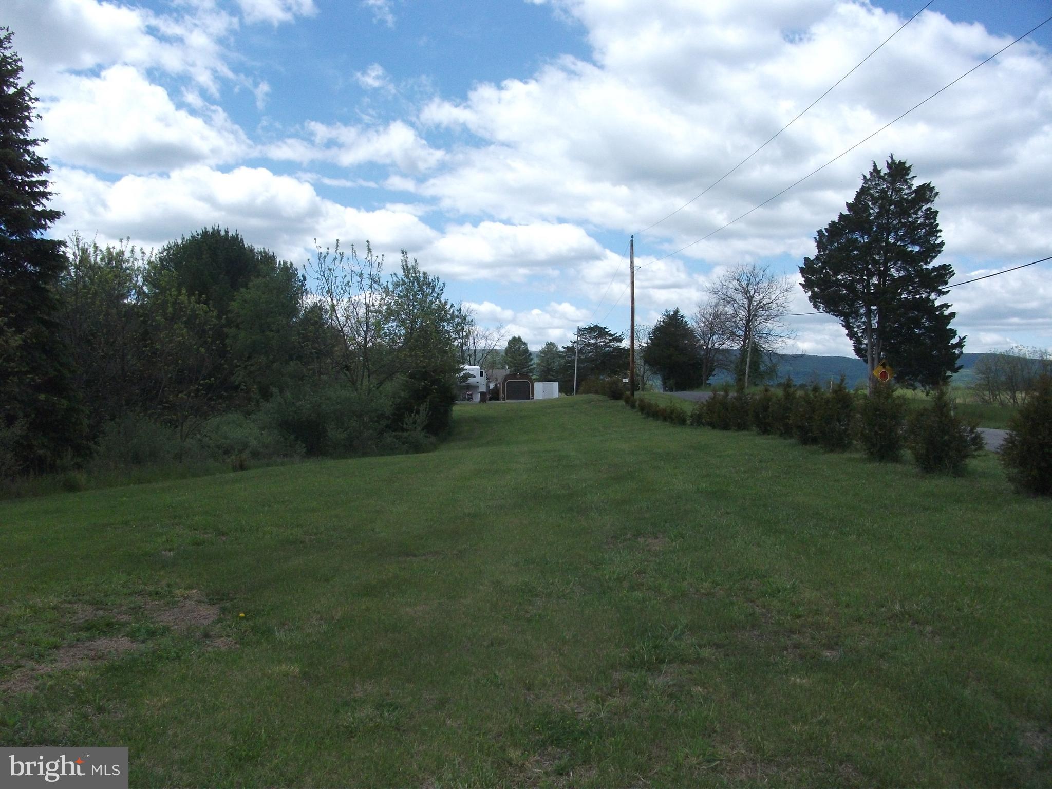 216 Garland Road Needmore, PA 17238 - Photo 35 of 38 a view of a grassy field with trees in the background