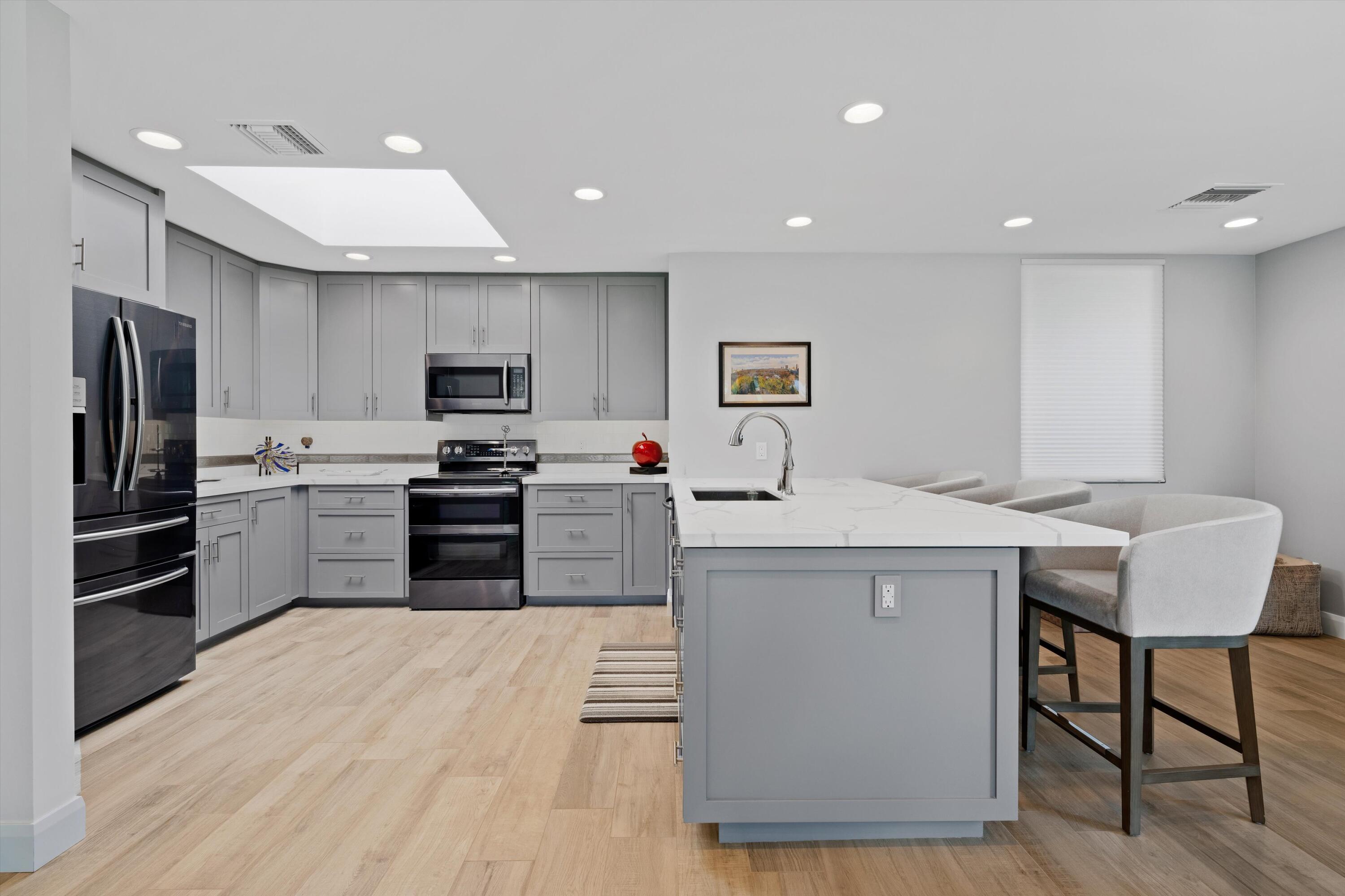 7 Wake Forest Court Rancho Mirage, CA 92270 - Photo 15 of 60 a kitchen with stainless steel appliances kitchen island granite countertop a sink and a refrigerator