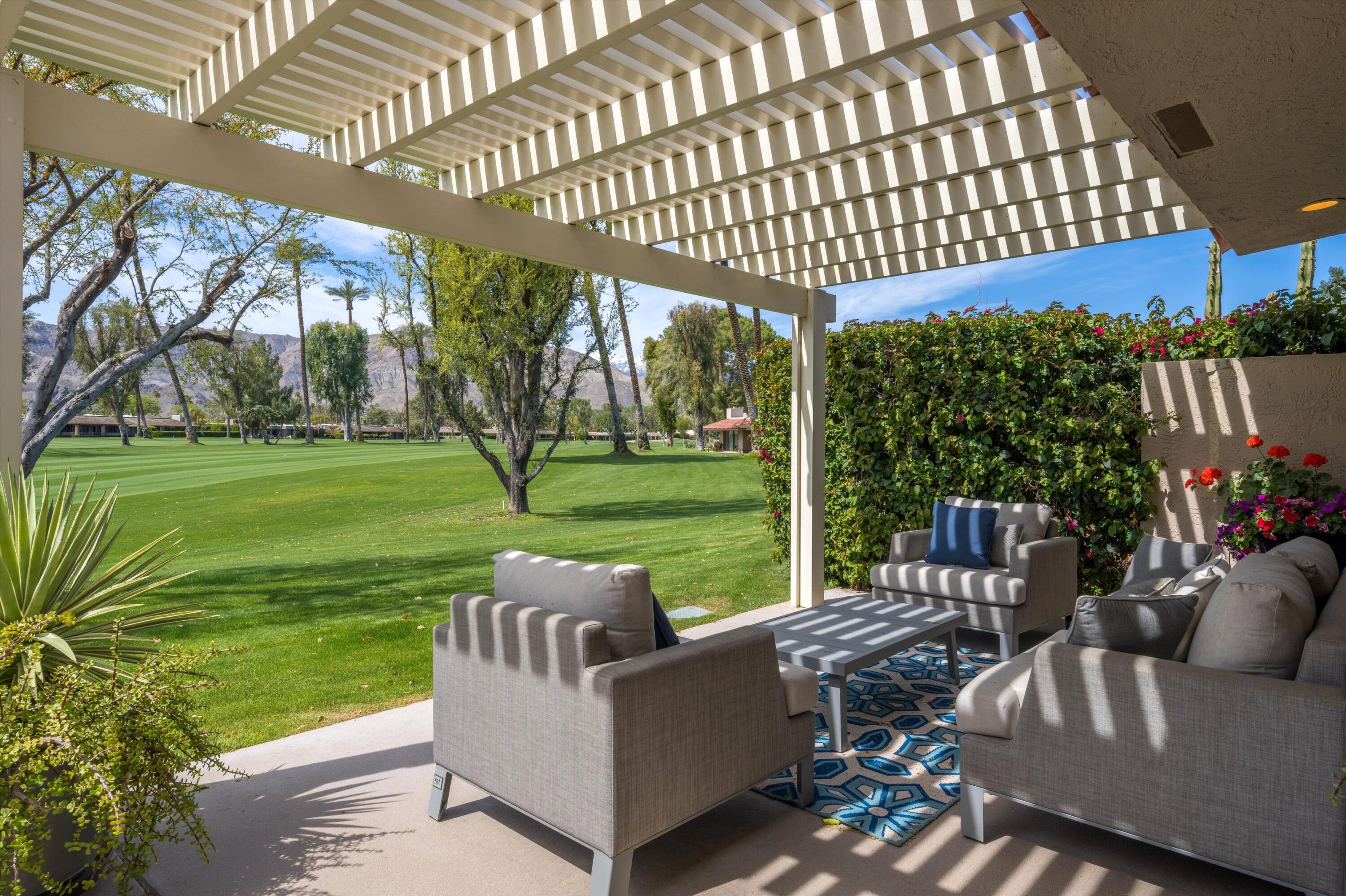 7 Wake Forest Court Rancho Mirage, CA 92270 - Photo 20 of 60 a view of a patio with couches chairs and a big yard