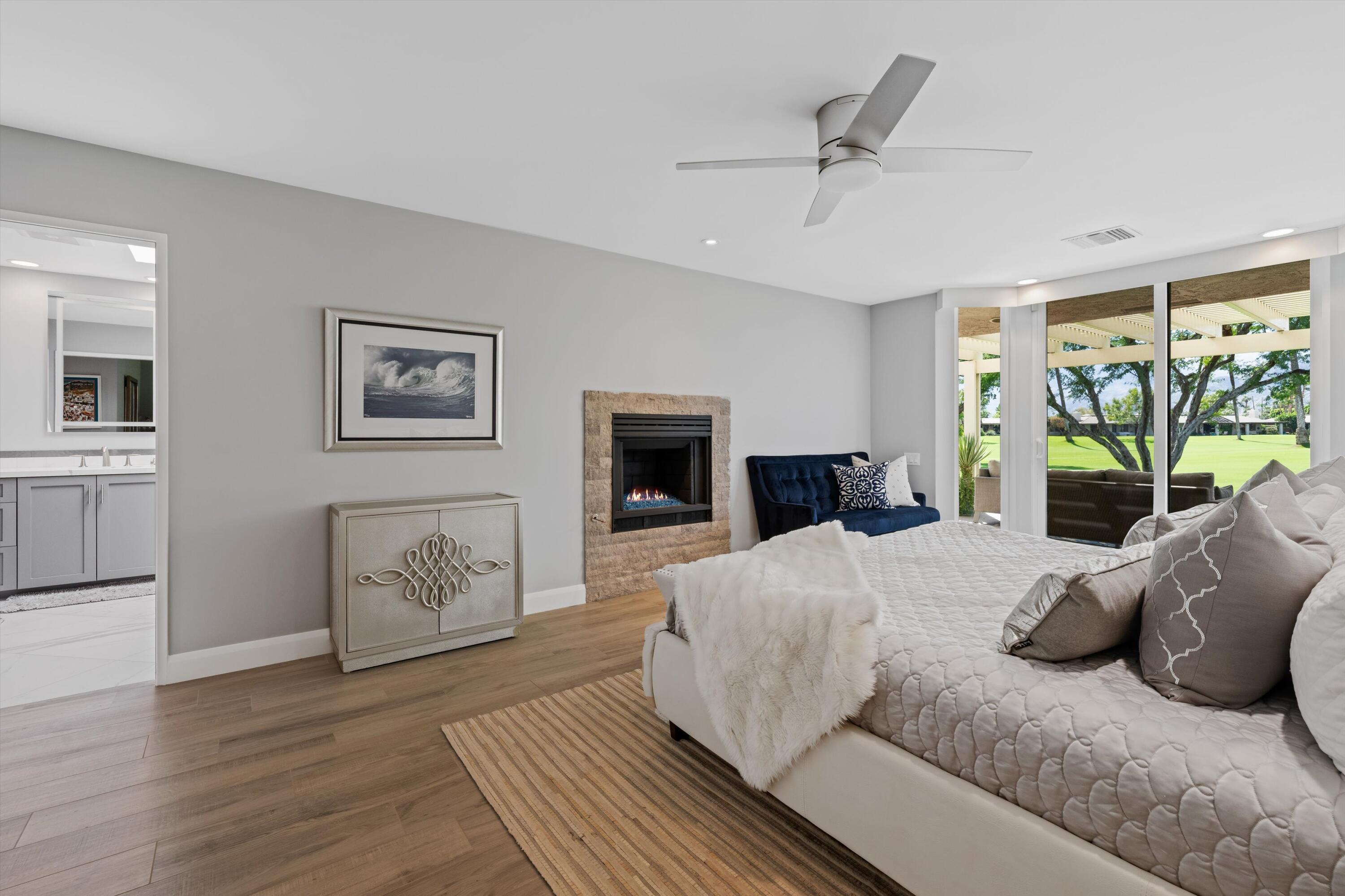 7 Wake Forest Court Rancho Mirage, CA 92270 - Photo 22 of 60 a bedroom with a bed and wooden floor