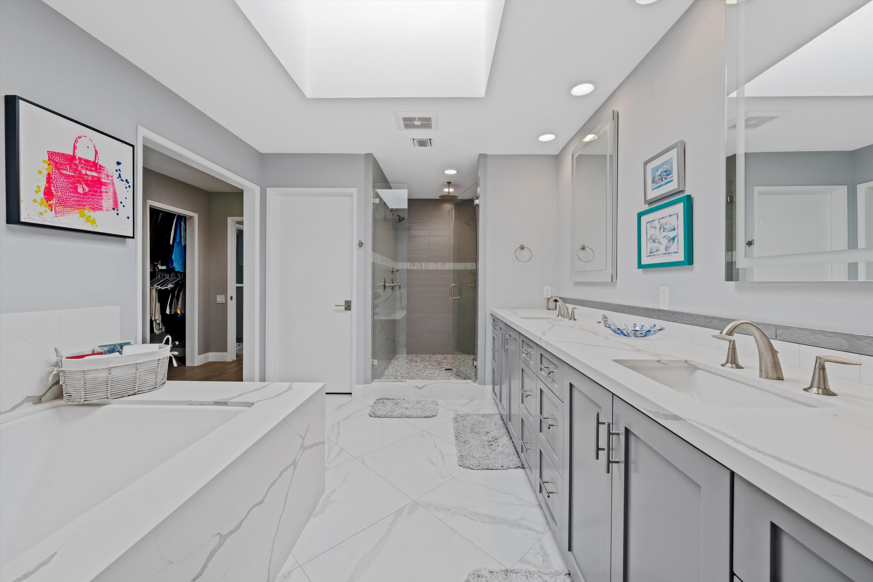 7 Wake Forest Court Rancho Mirage, CA 92270 - Photo 25 of 60 a spacious bathroom with a sink a shower and a mirror