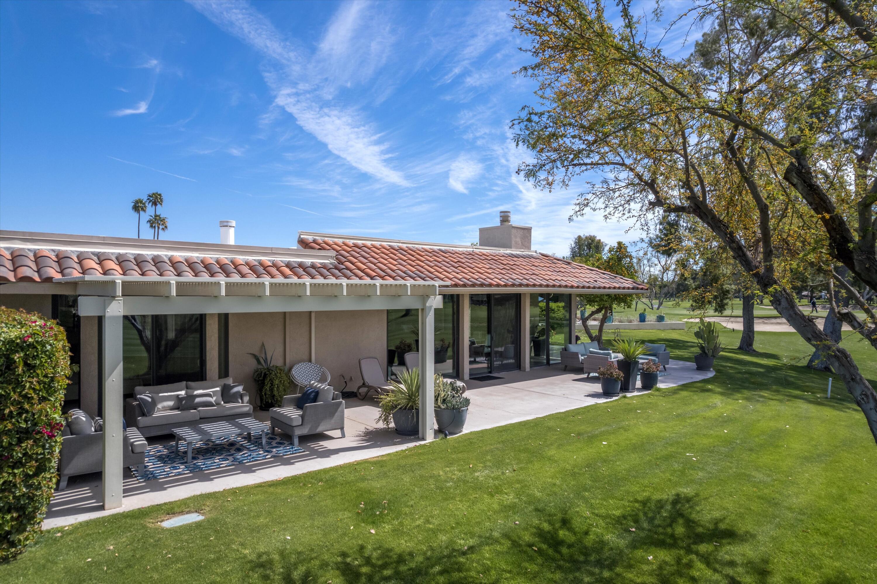 7 Wake Forest Court Rancho Mirage, CA 92270 - Photo 26 of 60 a view of a patio with table and chairs under an umbrella with a patio