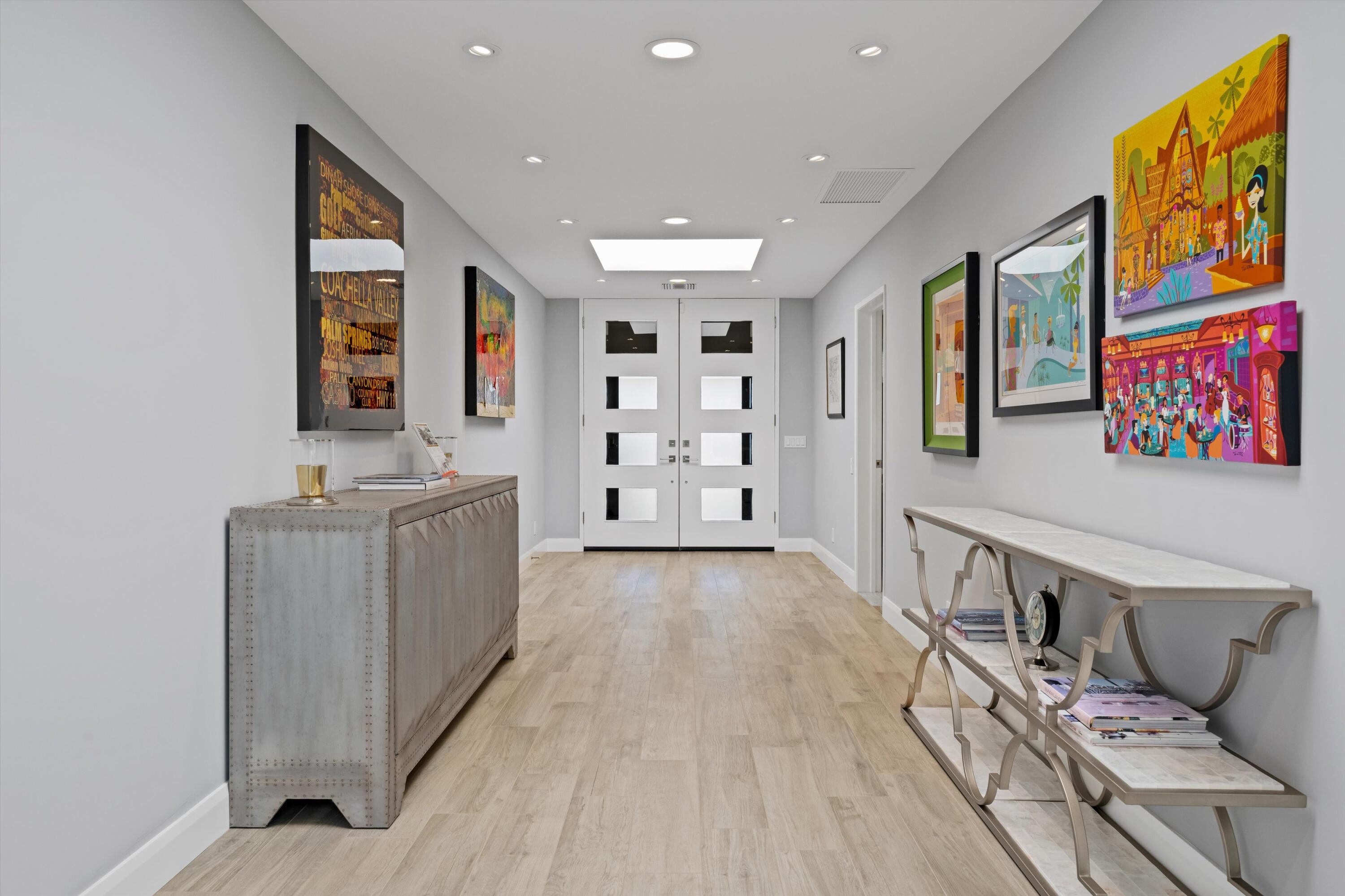 7 Wake Forest Court Rancho Mirage, CA 92270 - Photo 40 of 60 a living room with furniture and paintings on the wall
