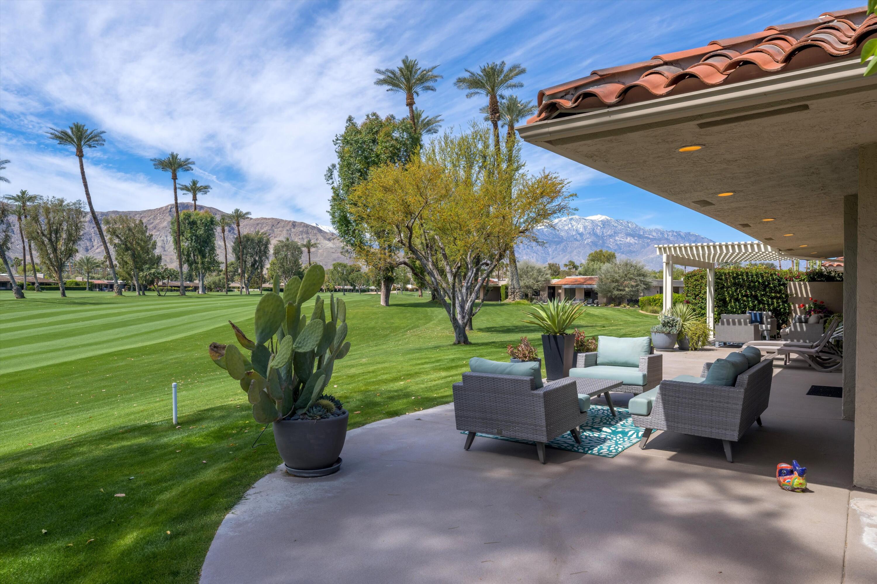 7 Wake Forest Court Rancho Mirage, CA 92270 - Photo 41 of 60 a view of a patio with a table chairs and a yard