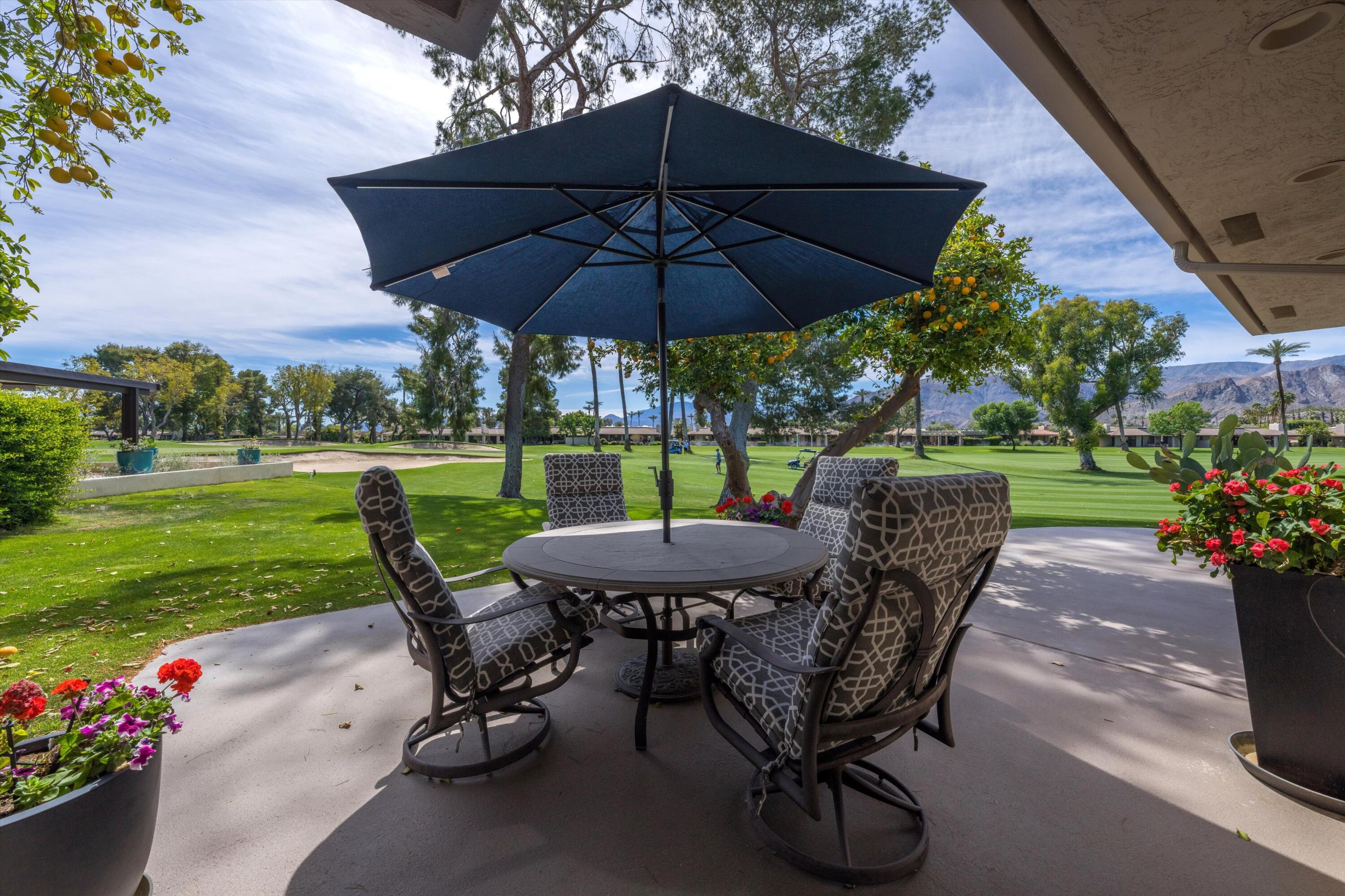 7 Wake Forest Court Rancho Mirage, CA 92270 - Photo 44 of 60 a view of a table and chairs in backyard