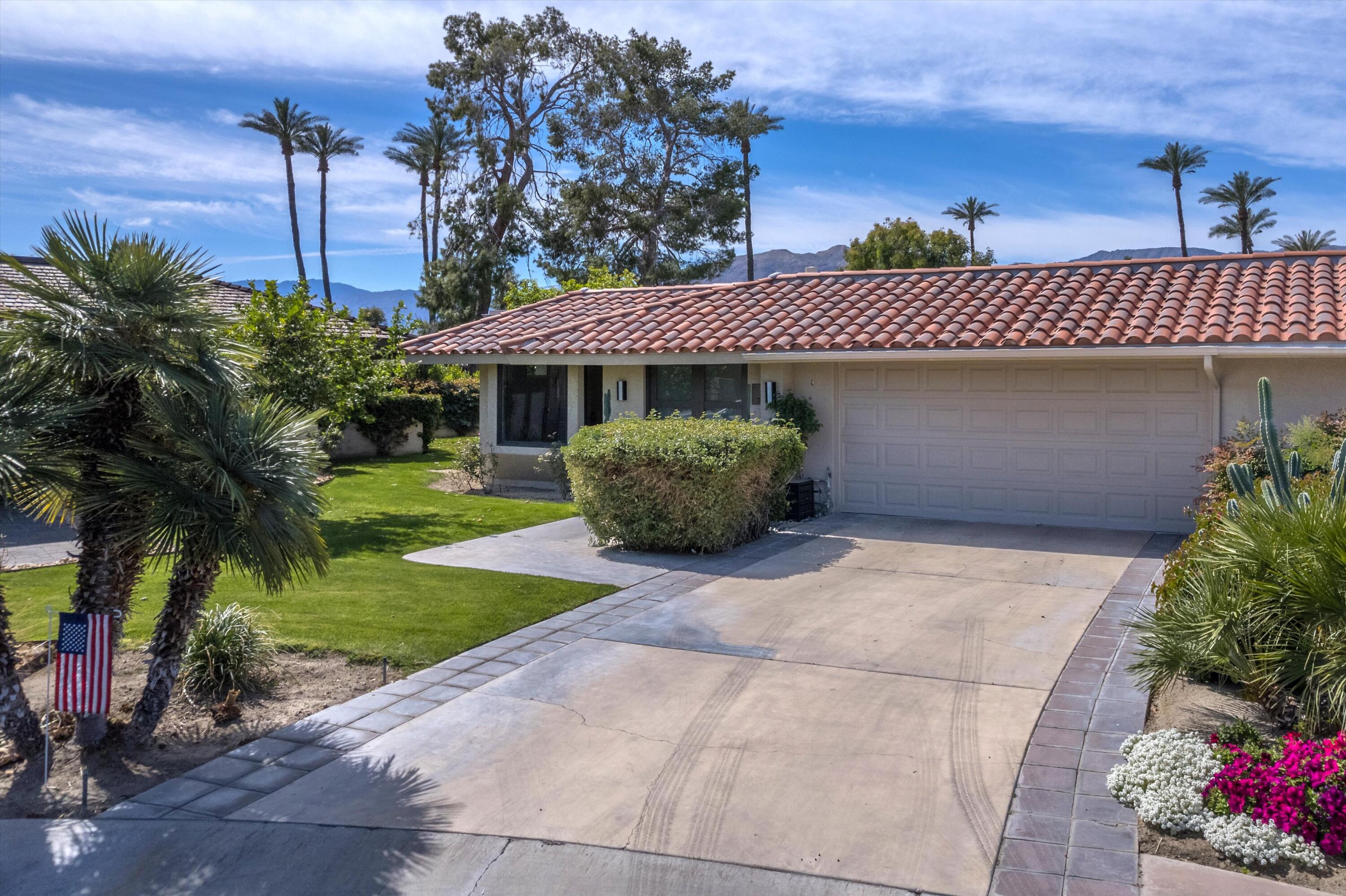 7 Wake Forest Court Rancho Mirage, CA 92270 - Photo 5 of 60 a front view of a house with a garden