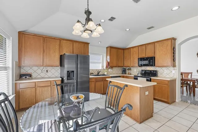a bedroom with a bed a chandelier and a window