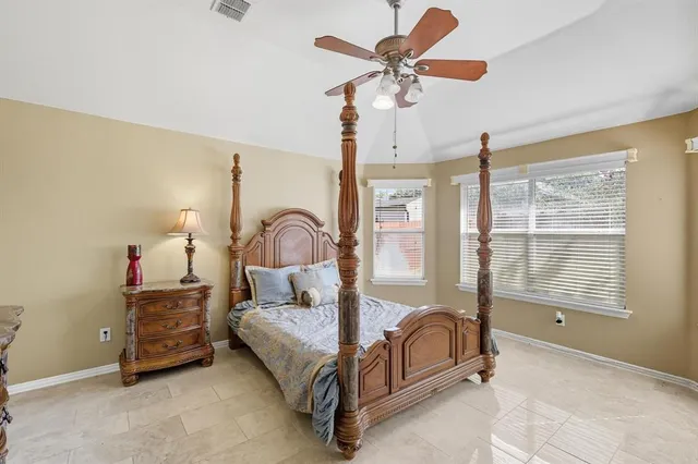 a bedroom with bed and flat screen tv
