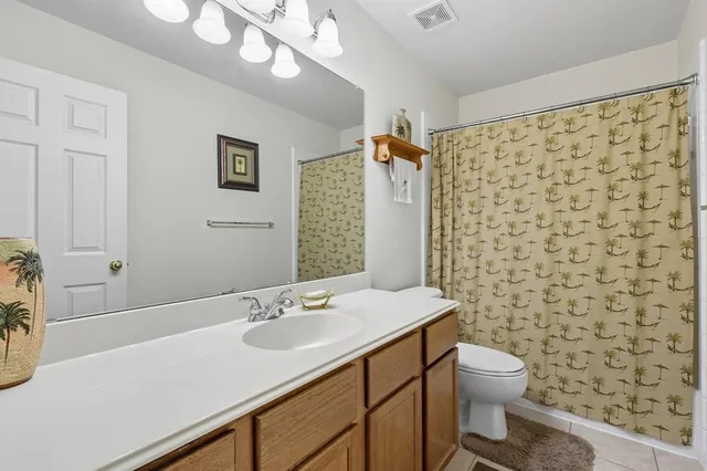 an empty room with a window and ceiling fan