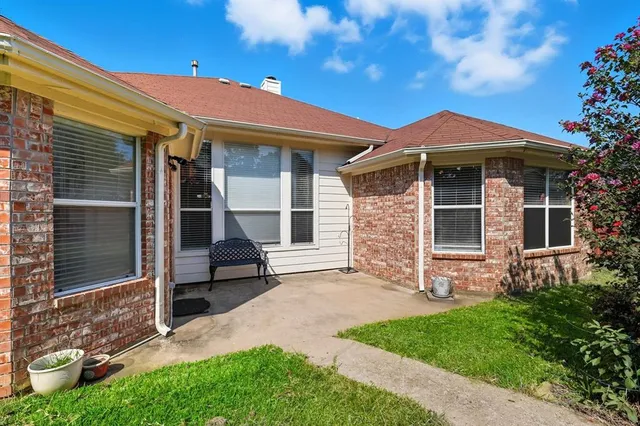 a view of a patio with a table chairs and a umbrella