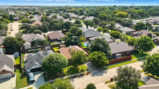 an aerial view of a house with a yard and lake view