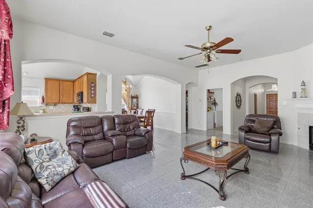 a living room with furniture a rug and a chandelier