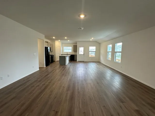a view of a room with wooden floors and fireplace