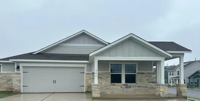 a front view of a house with garage