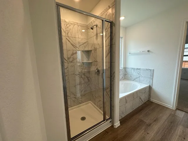 a bathroom with a tub and shower