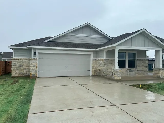 a front view of house with garage and green space
