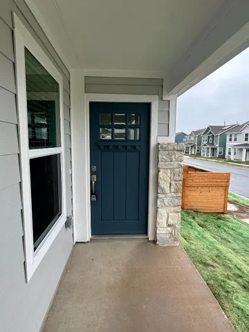 a view of an empty room with a fireplace and a window