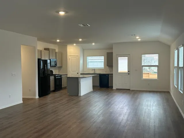 a view of kitchen with wooden floor and electronic appliances