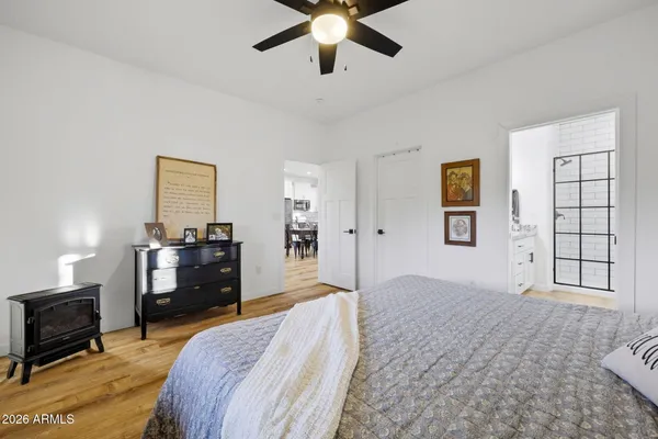 a bedroom with a bed and wooden floor