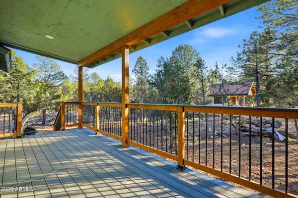 a balcony with wooden floor and outdoor space