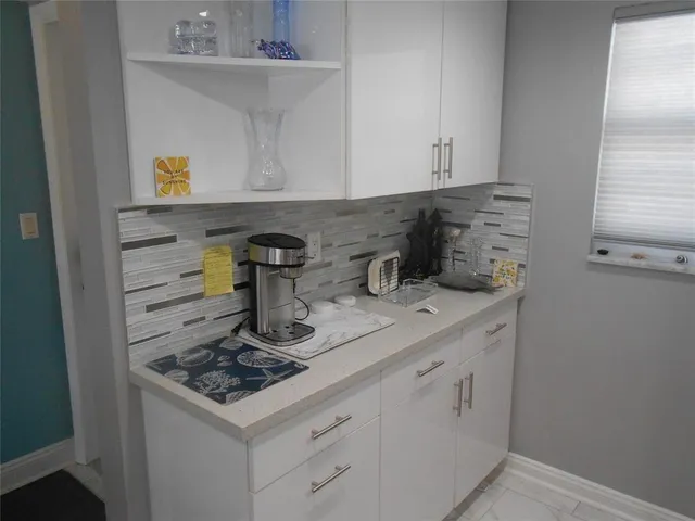 a kitchen with a sink and cabinets