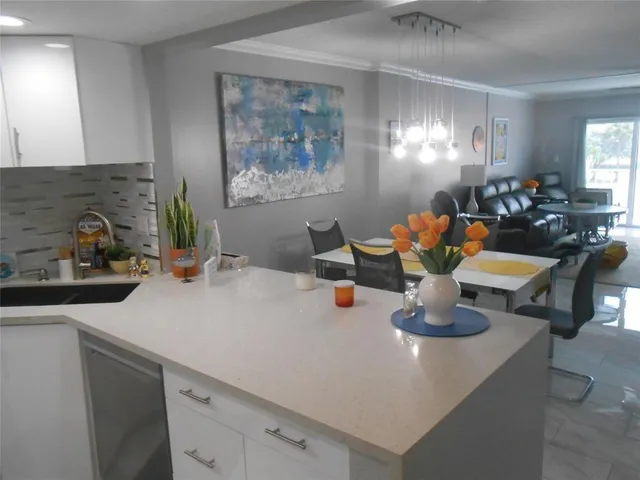 a view of a dining room with a table and chairs
