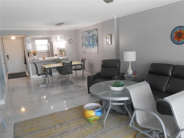 a living room with furniture a rug and a table