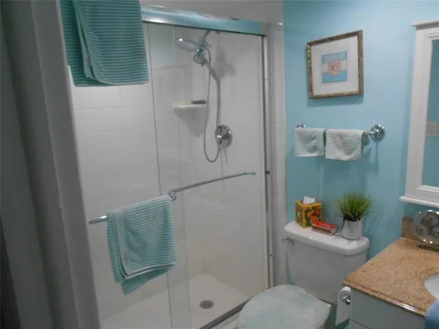 a bathroom with a shower and toilet
