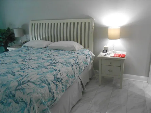 a bedroom with a bed and a dresser