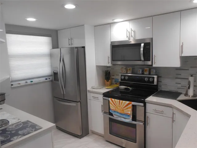 a kitchen with a refrigerator stove and microwave