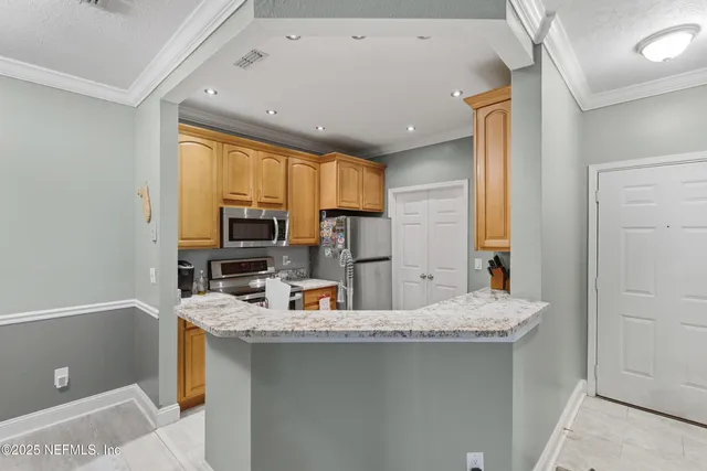a kitchen that has a sink and a stove in it