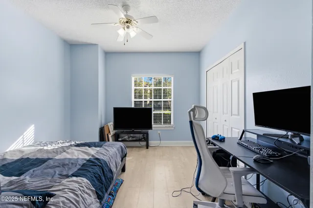 a bedroom with a bed a desk and chair