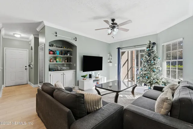 a living room with furniture and a chandelier