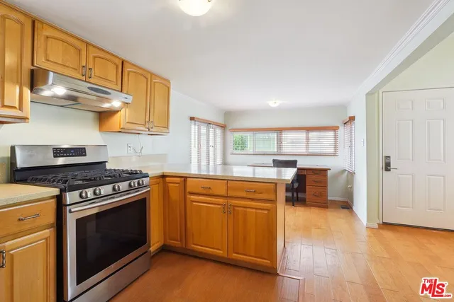 a kitchen with stainless steel appliances granite countertop a stove and a sink