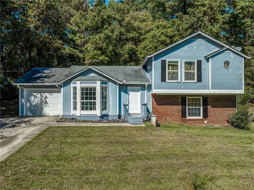 507 Wilson Mill Road Southwest Atlanta, GA 30331 - Photo 1 of 1 a front view of a house with a yard and garage