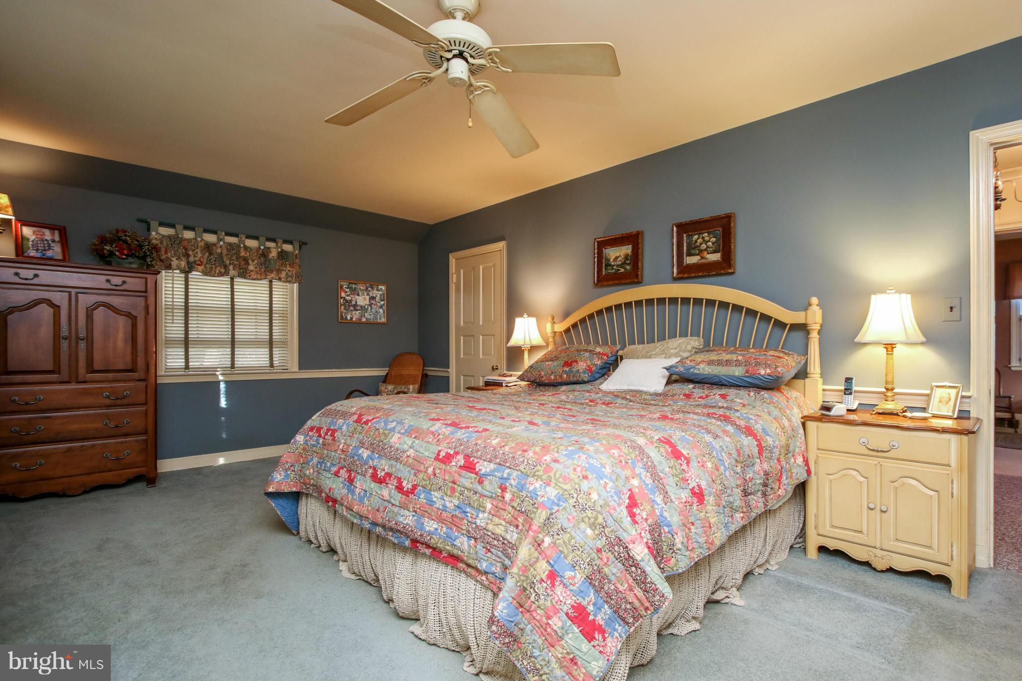 503 Worcester Road Towson, MD 21286 - Photo 11 of 18 a bedroom with a bed and a chandelier