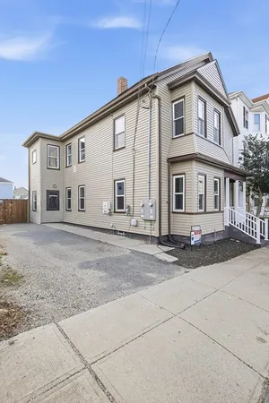 a front view of a house with a road