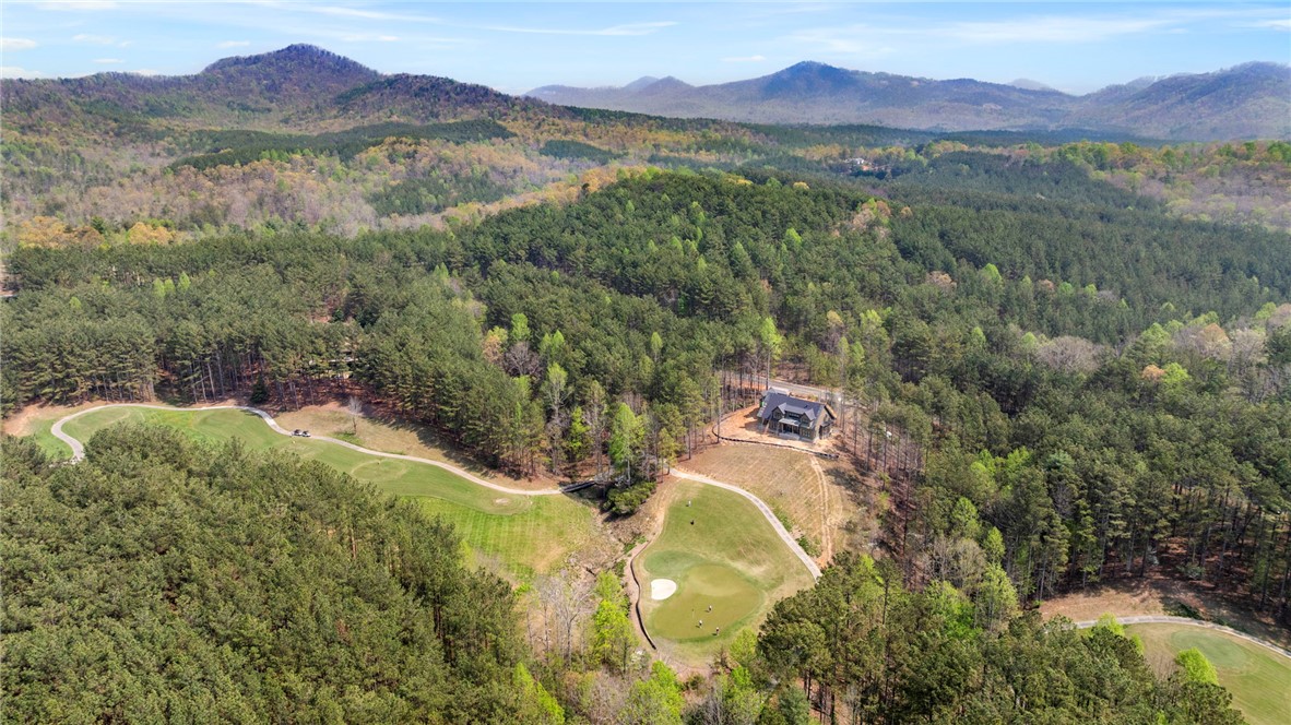 325 Keowee Avenue Sunset, SC 29685 - Photo 9 of 15 This elevated view captures a home nestled among lush trees, bordering a verdant golf course.