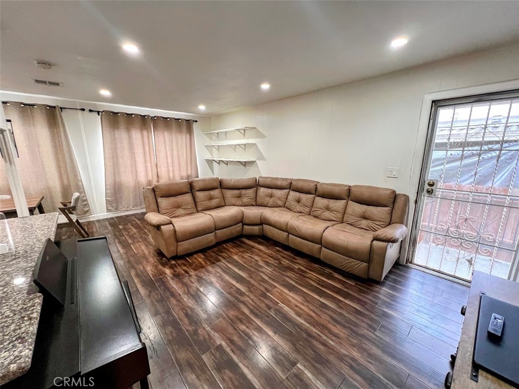 16600 Orange Avenue, Unit 124 Paramount, CA 90723 - Photo 2 of 16 a living room with furniture window and wooden floor