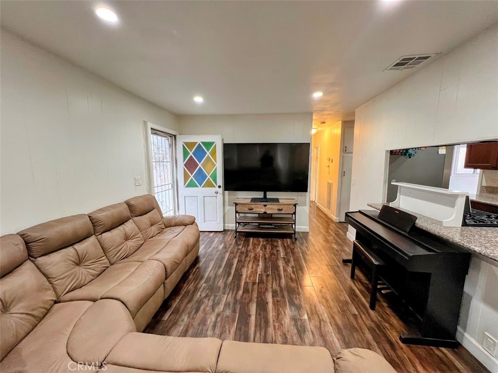 16600 Orange Avenue, Unit 124 Paramount, CA 90723 - Photo 3 of 16 a living room with furniture and a flat screen tv