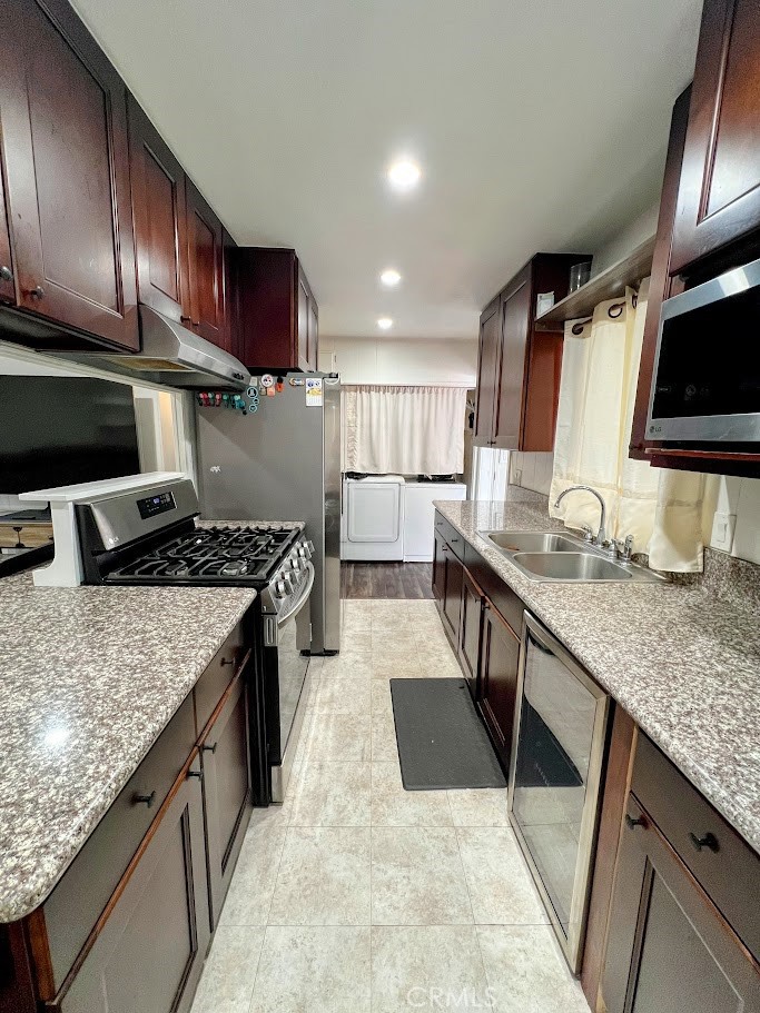 16600 Orange Avenue, Unit 124 Paramount, CA 90723 - Photo 6 of 16 a kitchen with stainless steel appliances granite countertop wooden cabinets a stove top oven a sink and dishwasher